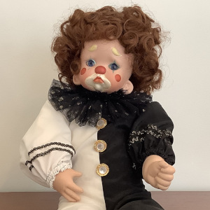 Baby Pierrot doll in black and white costume with clown makeup