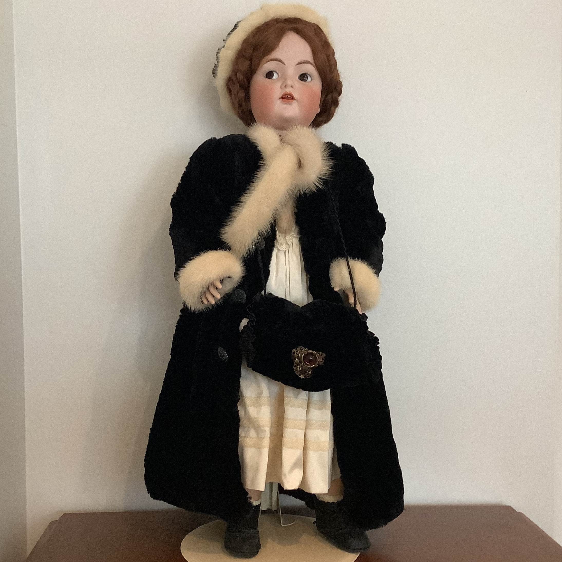 Reproduction Rosalind doll in a black fur coat with white trim, front view