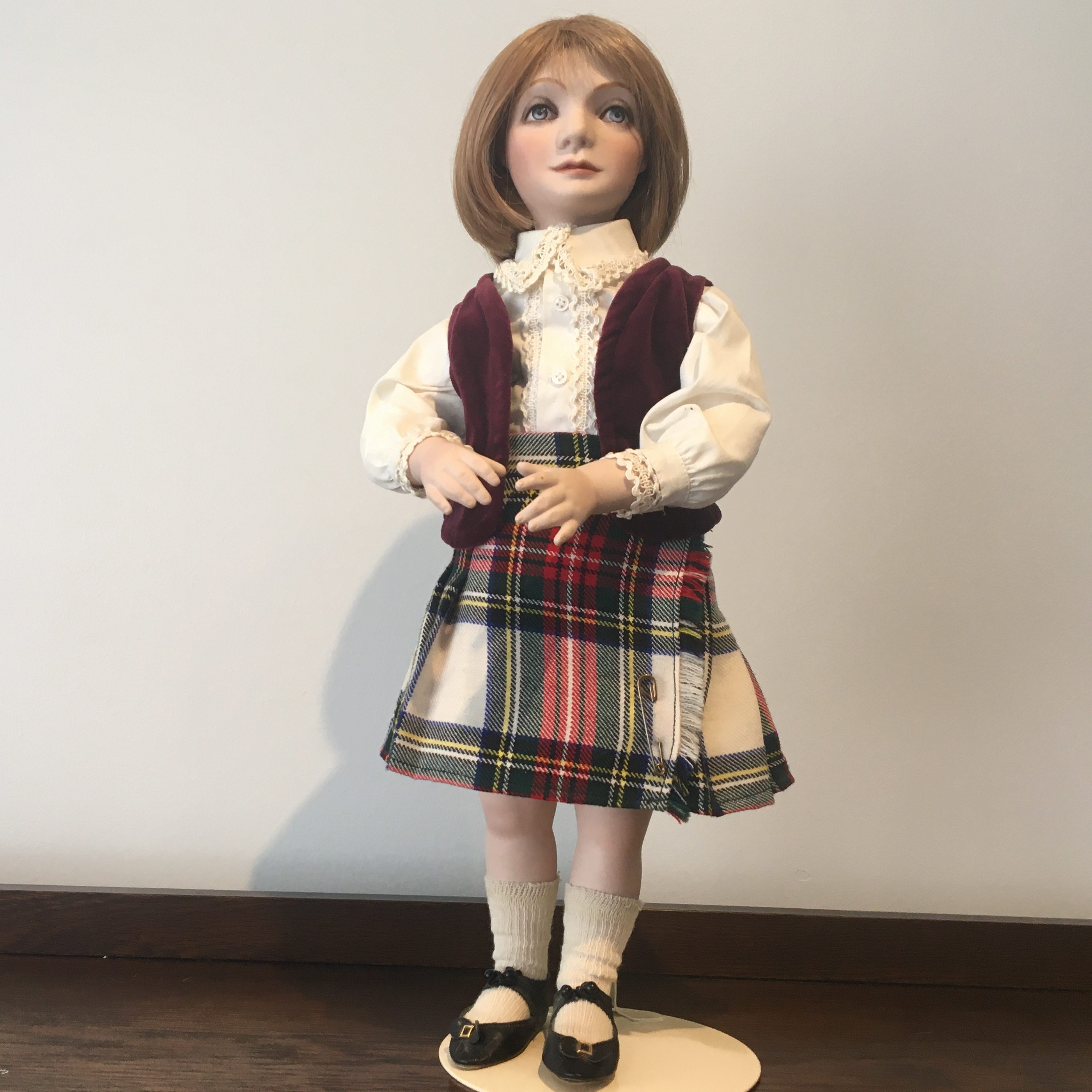 19-inch sculpted modern doll with painted eyes, kilt and vest with white lace-edged blouse