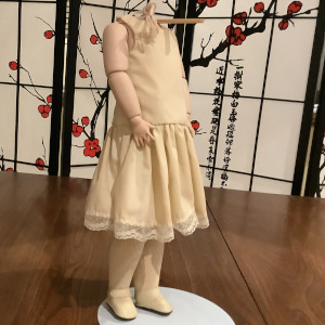 Composition doll body in off-white cotton slip, head not included