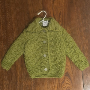 green cardigan knit in a basketweave stitch