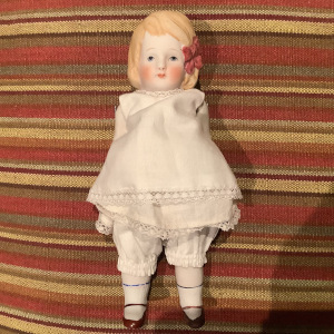 Vintage child doll with jointed arms and legs