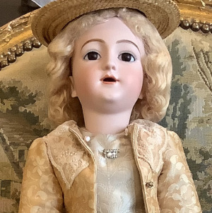 Tall, blond lady doll in camel satin jaquard suit with beige top and skirt underneath