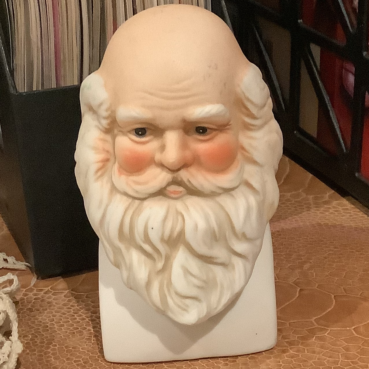 Head of old, light-skinned man with reddish nose and cheeks, bald spot on top of head and bushy white beard and moustache