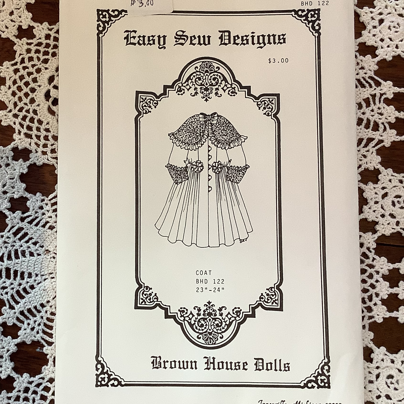 Sewing pattern to make an ornate fur-trimmed coat for a 22 to 23-inch doll