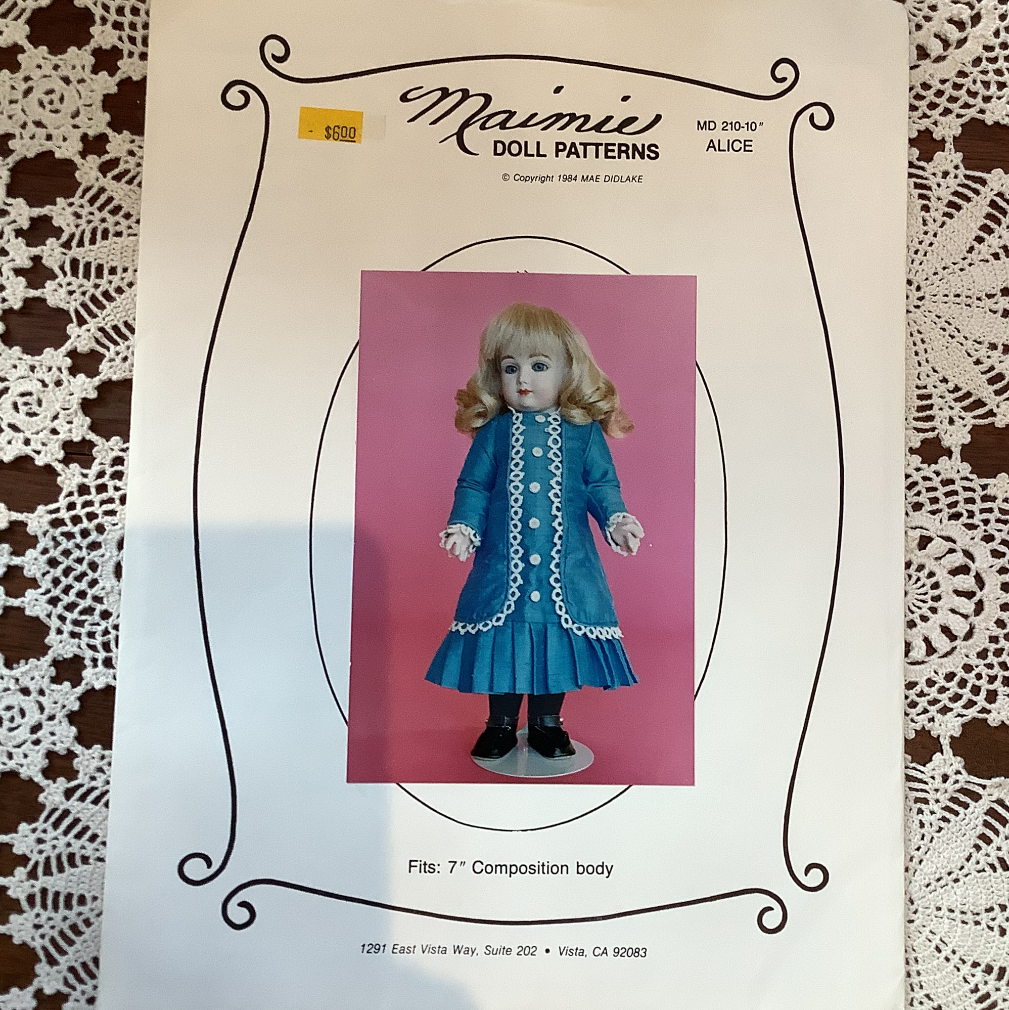 Sewing pattern to make lace-trimmed dress for 7-inch child doll