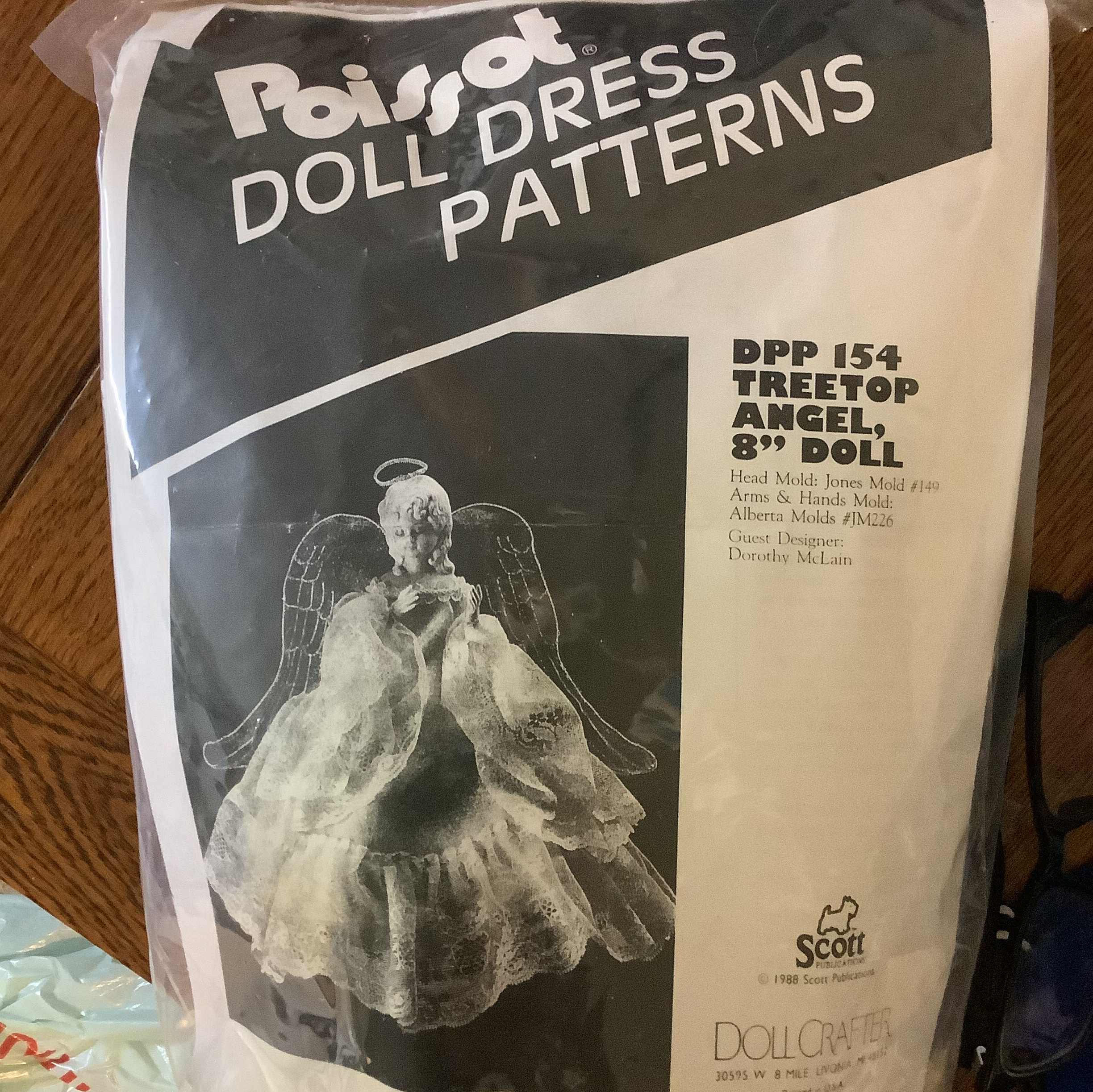 plastic bag containing a black-and-white picture of a treetop angel and text describing the kit as fitting Jones Mold #149. Several other objects are also in the bag but are obscured behind the picture