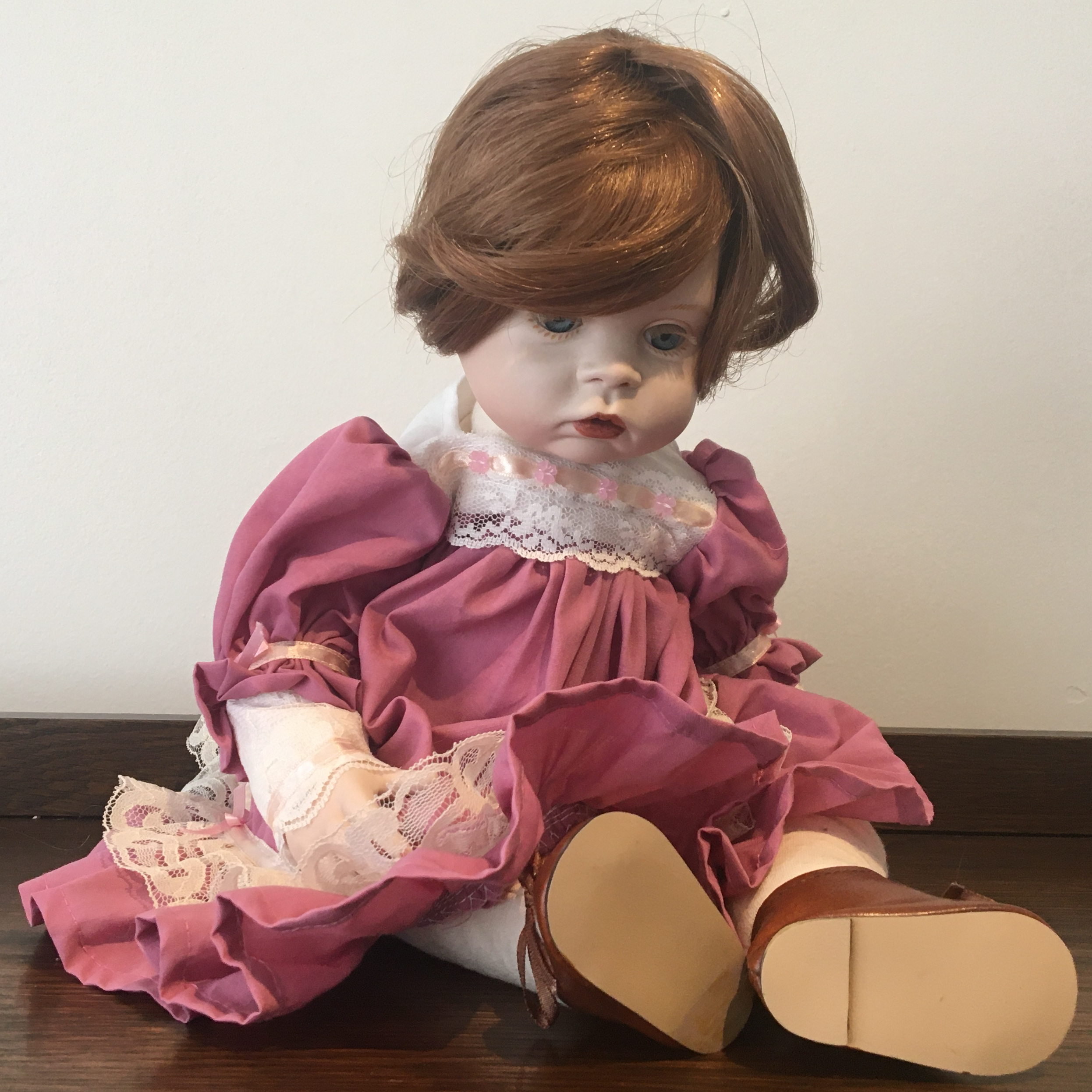 17-inch modern Gumdrop doll with auburn hair and pink dress, seated
