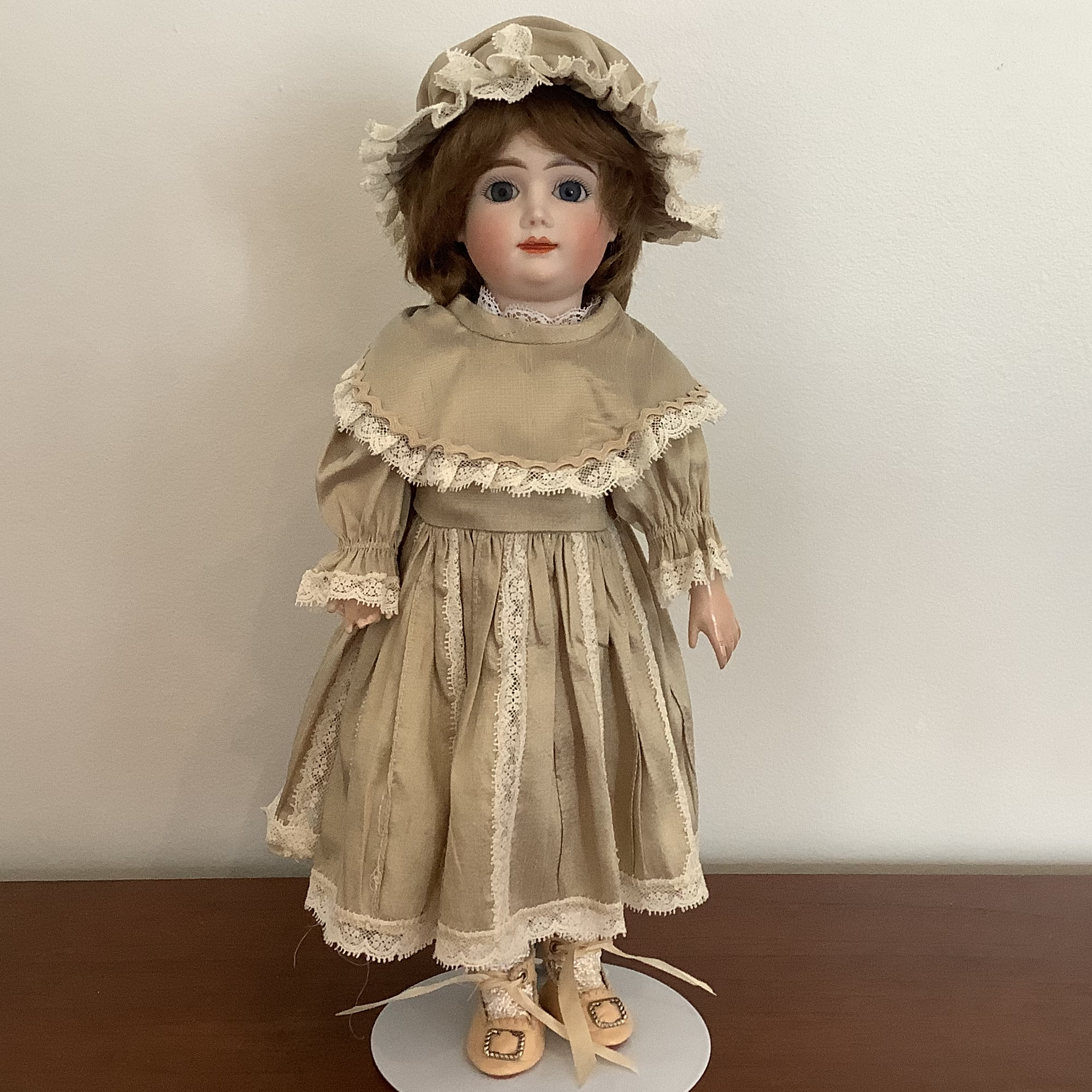 AT Nina reproduction in dark beige or light taupe dress by Lirie Aliaj, front view.