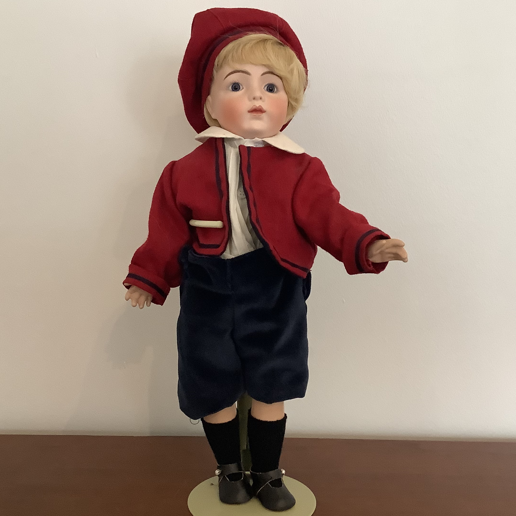 Small 15-inch reproduction Bru boy doll in red and blue suit, front view