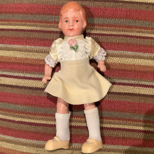Vintage child doll with jointed arms and legs